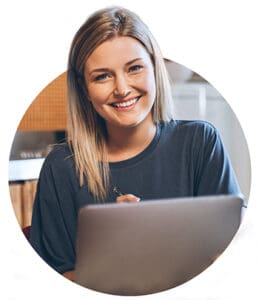 Portrait of an attractive young blonde woman sitting at a table in her kitchen using a digital tablet