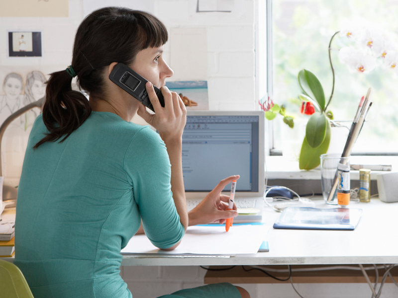 woman in office talking on a telephone